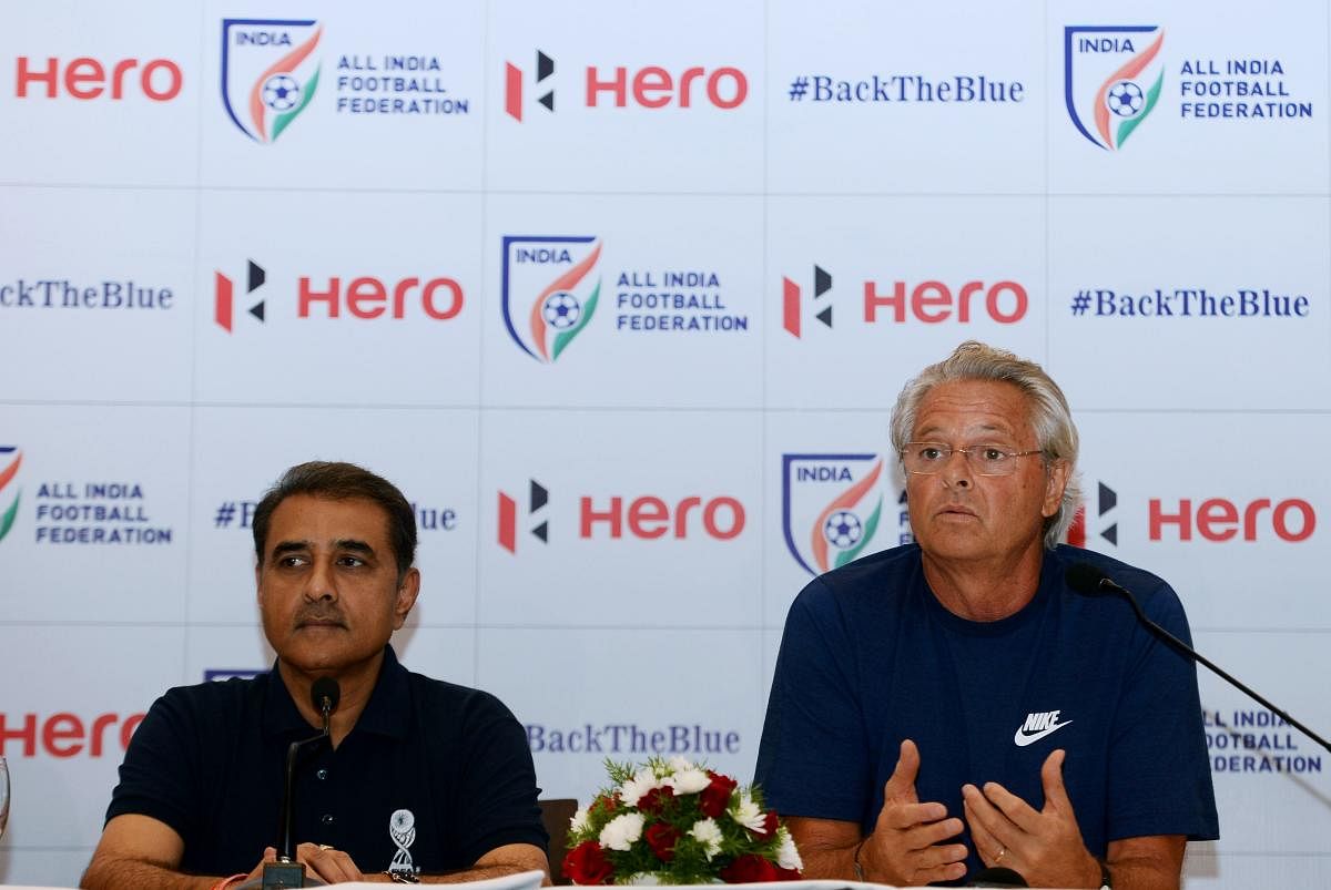 Former Portuguese footballer and under 17 Indian football team coach Luis Nortan De Matos (R) speaks next to All India football federation (AIFF) president Praful Patel during a press conference in New Delhi on September 26, 2017. / AFP PHOTO / SAJJAD HUSSAIN