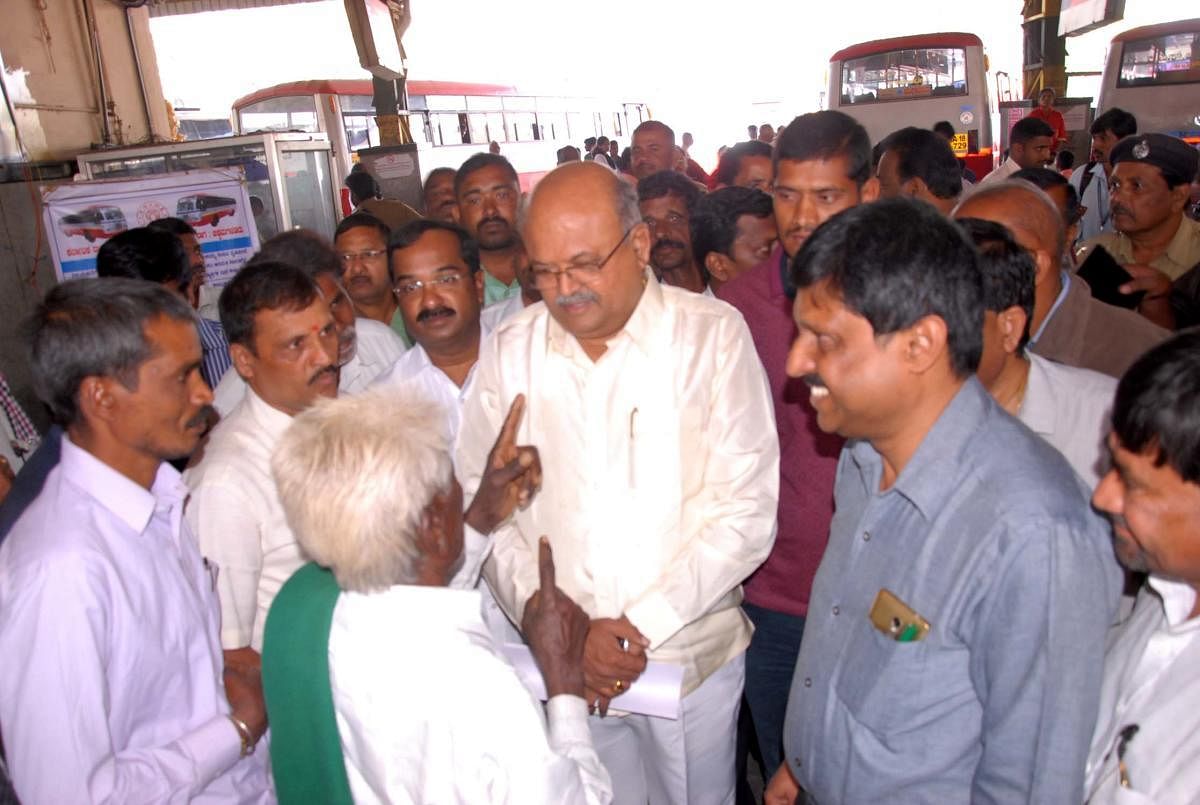 Demanding bus facilities to Kyathanabeedu, resident Channe Gowda submits a petition to Transport Minister Revanna.