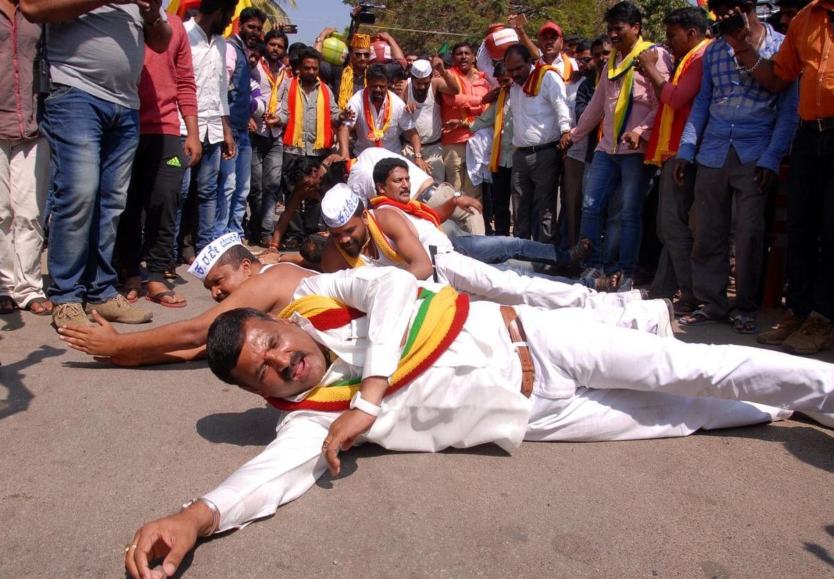 Protesters undertake 'Urulu Seve' on the streets of Chikkamagaluru town during the state bandh on Thursday.