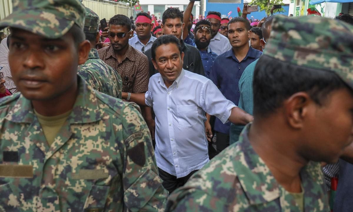 Maldivian president Yameen Abdul Gayoom, center, surrounded by his body guards arrives to address his supporters in Male, Maldives. AP/PTI Photo