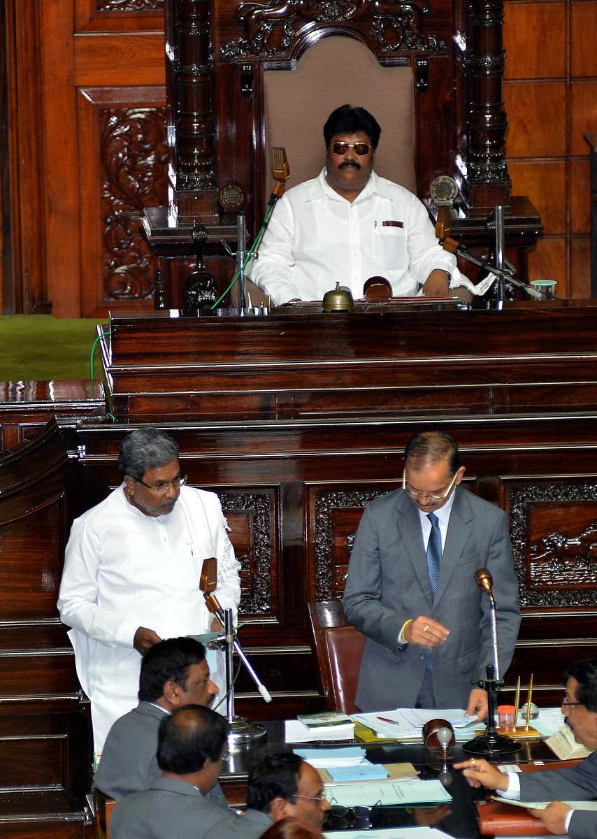 Chief Minister Siddramaiah taking oath at the first day of Legislative Assembly sessions of 14th Assembly, at Vidhana Soudha in Bangalore on Wednesday. Protem speaker Malikayya V Guttedar is also seen. -Photo/ ABoath