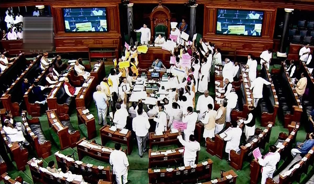 Opposition members protest during the ongoing budget session of Parliament at the Lok Sabha in New Delhi on Monday. PTI