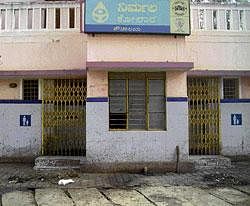 opposite directions: The doors of the public toilet in Kurubarapet, Kolar are shut
