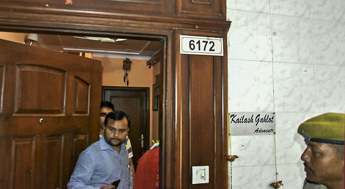 Income Tax officials conduct a raid at Delhi transport minister Kailash Gahlot's residence in connection with an alleged tax evasion case in New Delhi on Wednesday. (PTI Photo)