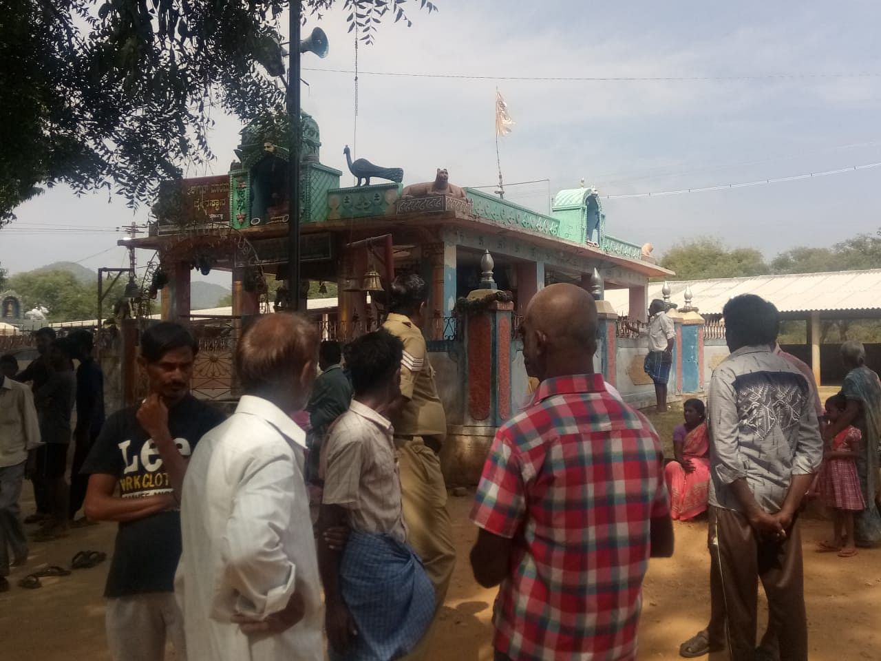 People outside the temple at Sulvadi village in Hanur taluk, Chamarajanagar district. (DH Photo)