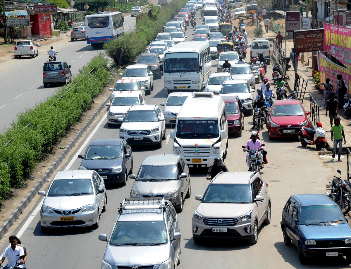 Traffic congestion, like this one on Mysuru Road in Bengaluru, could become the order of the day in both the cities once the highway is six-laned as more people opt for private vehicles. DH FILE PHOTO