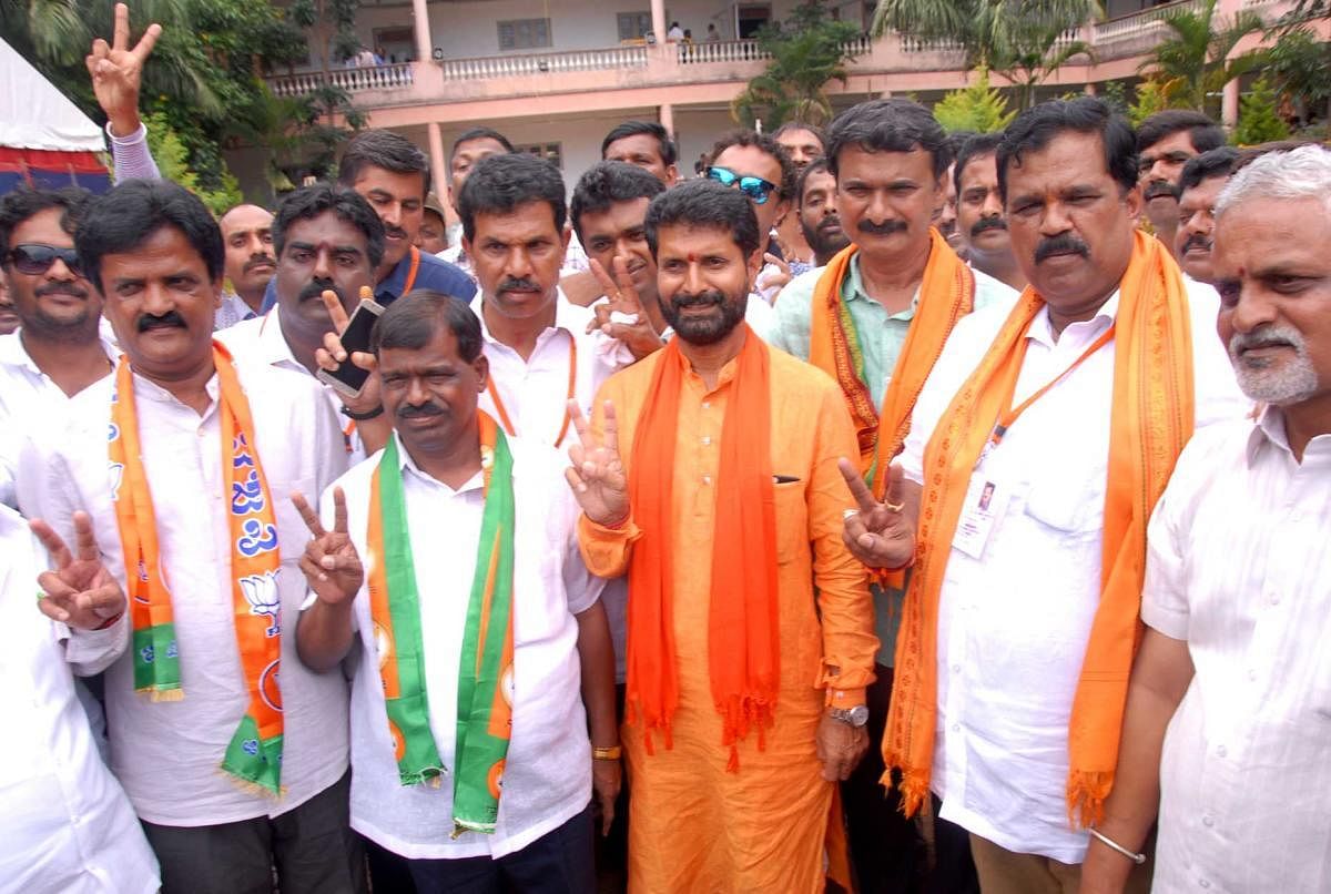 Chikkamagaluru BJP candidate C T Ravi shows the victory sign after winning the election in Chikkamagaluru.