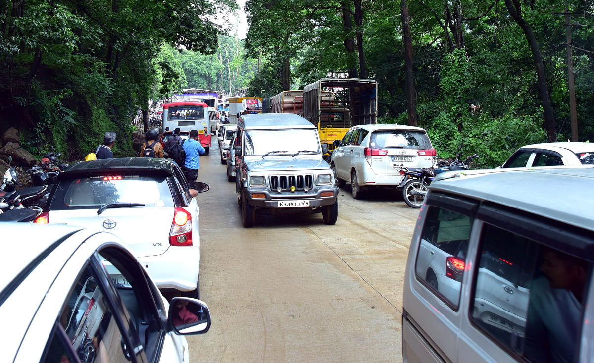 Vehicles move on the newly concreted Shiradi Ghat road on Sunday. DH Photo/Govindraj Javali