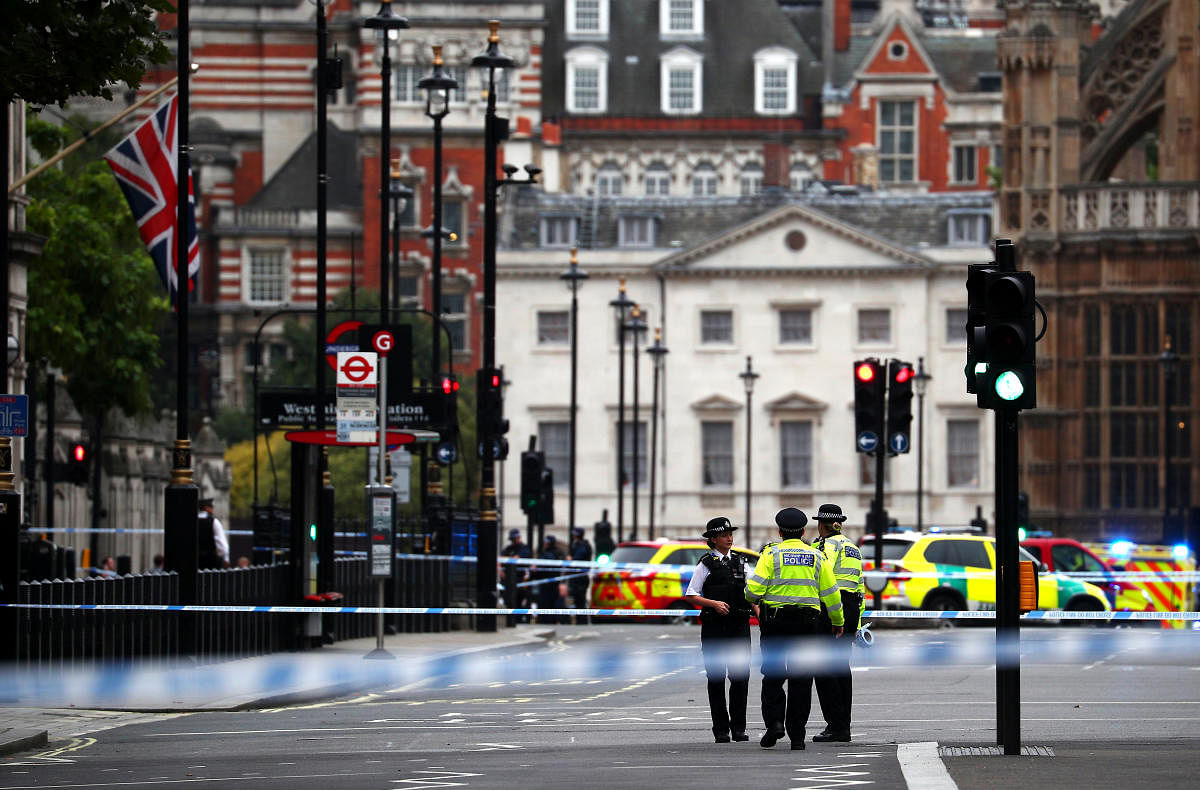 Police stand in the street after a car crashed outside the Houses of Parliament in Westminster, London. Reuters photo