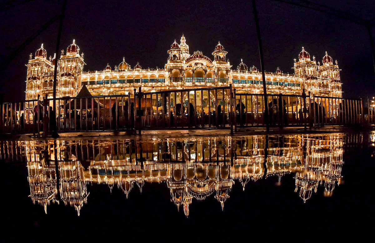 Spellbinding: The illuminated Mysuru palace is reflected in rainwater on Wednesday. dh photo