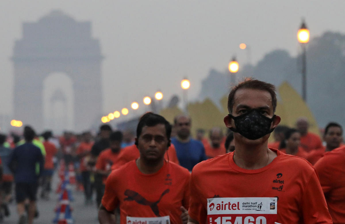 A runner wearing a face mask for protection from air pollution takes part in the Airtel Delhi Half Marathon in New Delhi. (Reuters Photo)