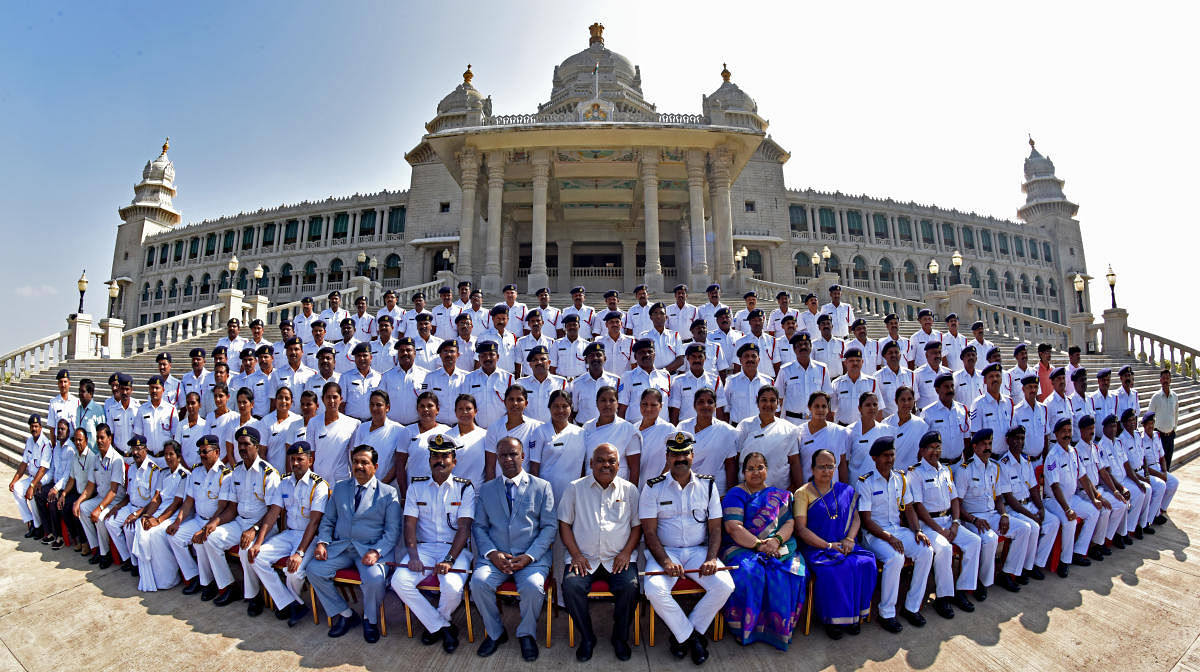 The marshalls of the House pose for a group photo with Assembly Speaker K R Ramesh Kumar in front of the Suvarna Vidhana Soudha in Belagavi on Friday, the last day of the winter session of the legislature. DH Photo/M S Manjunath