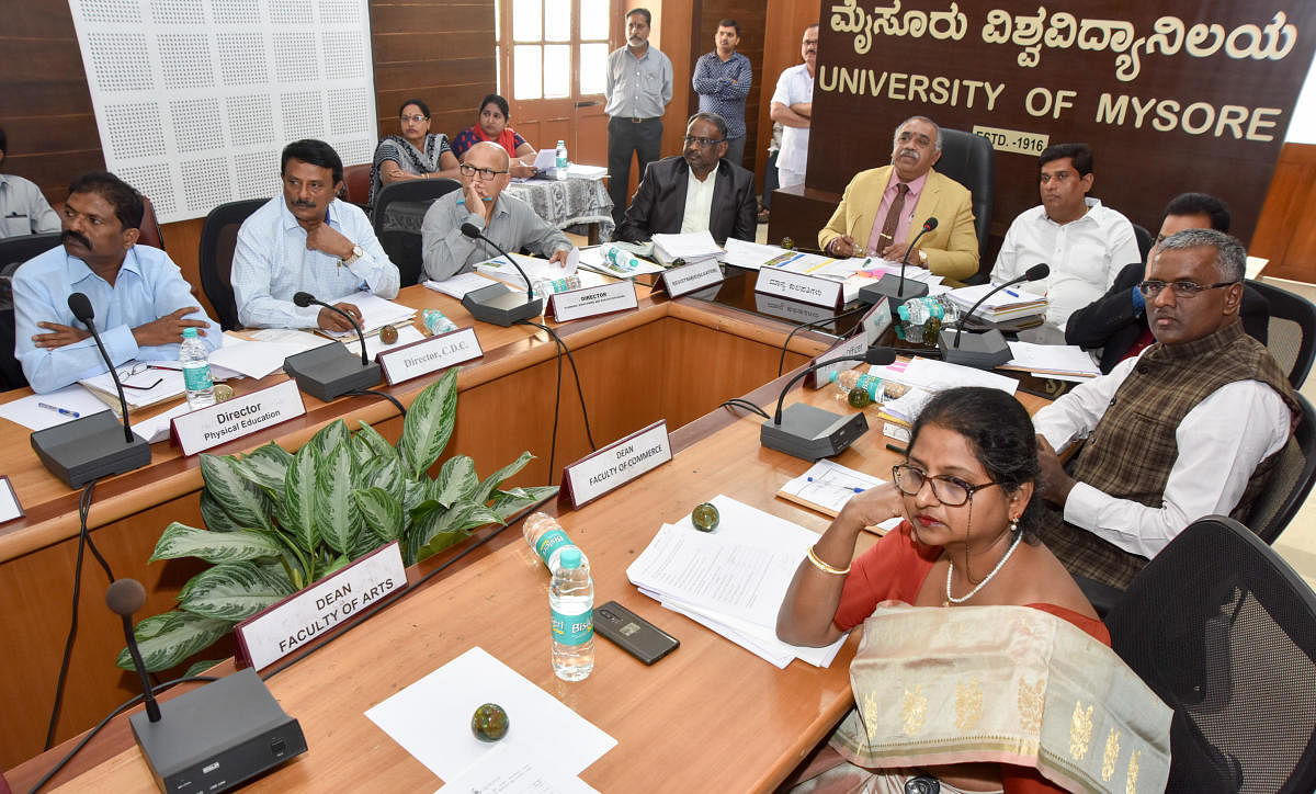University of Mysore Vice Chancellor G Hemantha Kumar chairs the Academic Council meeting at Crawford Hall, the administrative building of the university, in Mysuru on Monday. In-charge director for Physical Education P Krishnaiah, CDC Director S Srikanta