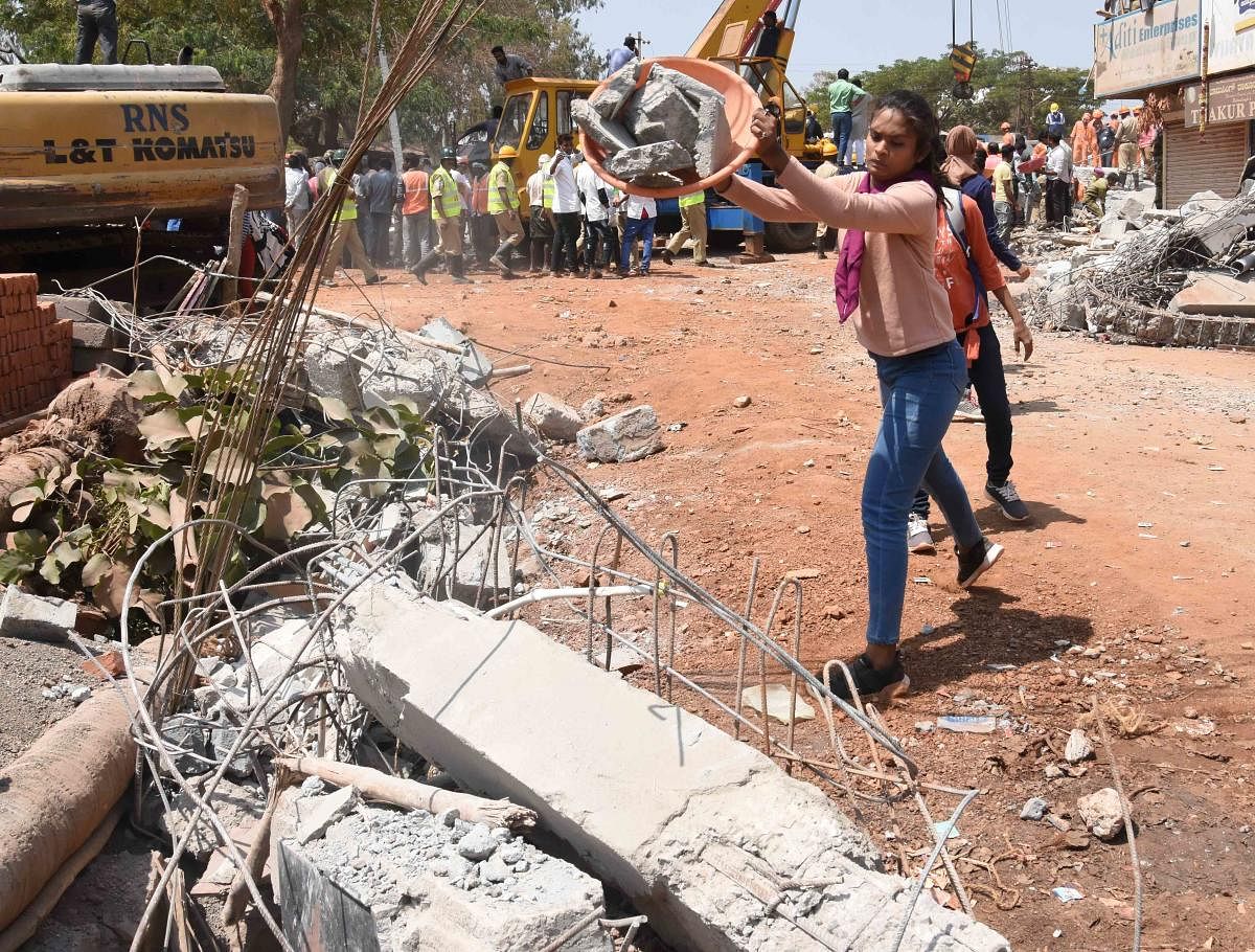 Students clear debris at the building collapse site.