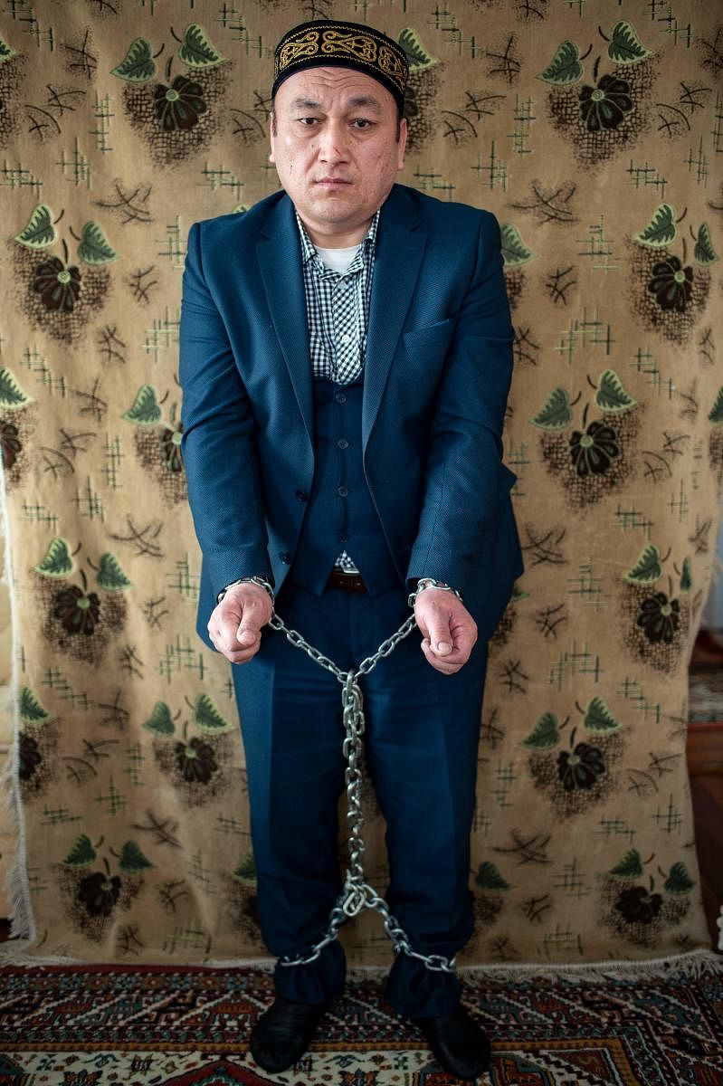 Omir Bekali, a Kazakh who was imprisoned and sent to a "reeducation camp" in China, shows how he was chained during his detention during an interview in Istanbul. AFP.