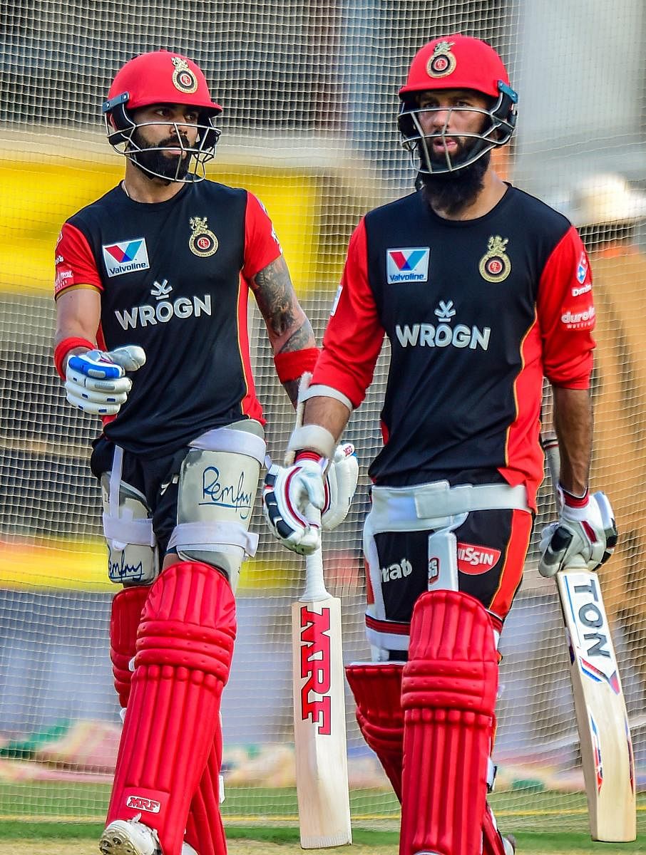 Skipper of Royal Challengers Bangalore (RCB) Virat Kohli and team-mate Moeen Ali during a practice session ahead of IPL 2019 at MAC Stadium in Chennai on Friday. PTI