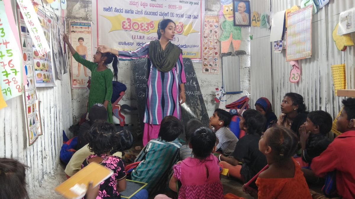 Roushan Banu, a teacher at tent school in the Shahi Nagar near Bannimantap, teaching children of migrants workers in Mysuru city.