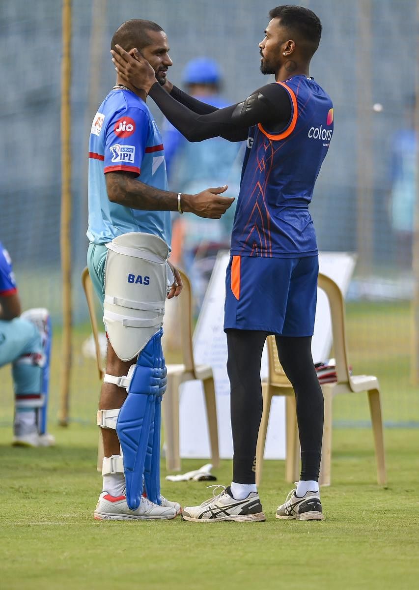 Delhi Capitals' Shikhar Dhawan (left) and Mumbai Indians' Hardik Pandya chat during a training session ahead of their IP game on Sunday. PTI 