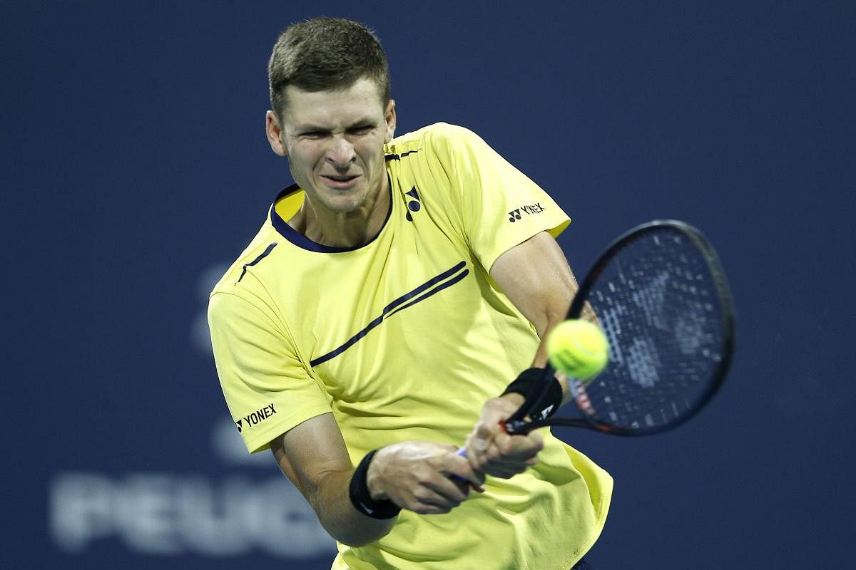 Poland's Hubert Hurkacz returns during his win over Dominic Thiem of Austria on Friday. AFP