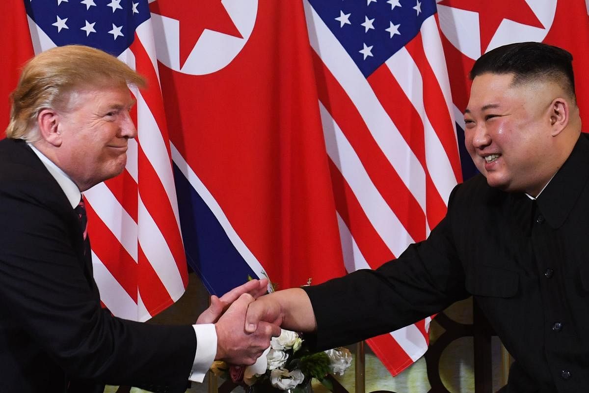 (FILES) In this file photo taken on February 27, 2019 US President Donald Trump (L) speaks with North Korea's leader Kim Jong Un during a meeting at the Sofitel Legend Metropole hotel in Hanoi. - President Donald Trump on March 22, 2019, abruptly announce