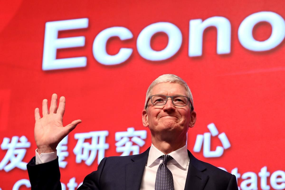 Apple CEO Tim Cook waves as he arrives for the Economic Summit held for the China Development Forum in Beijing on March 23, 2019. (AFP)
