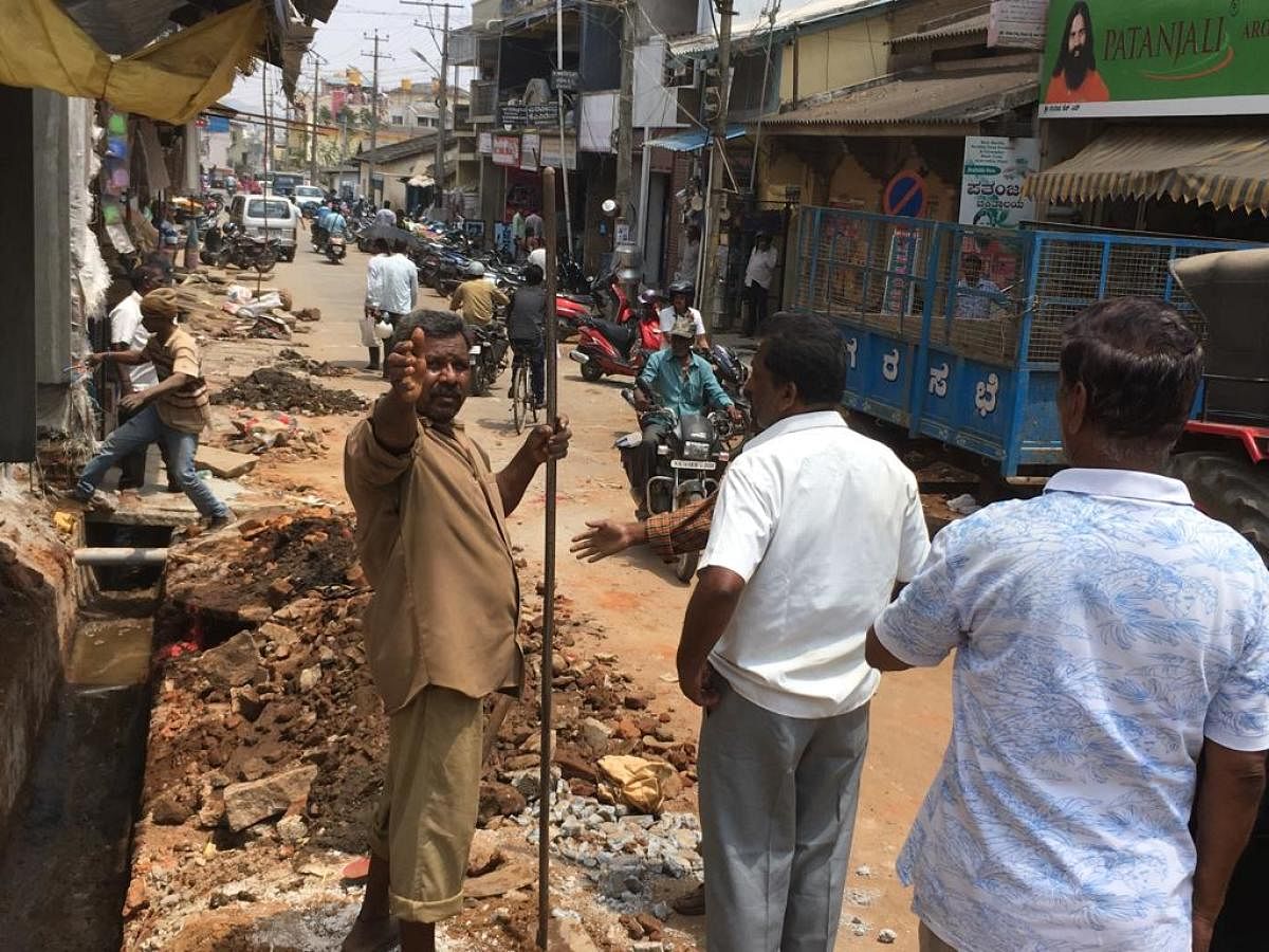 The encroachment of footpath being cleared at Shettarabeedi in Chikkamagaluru on Saturday.