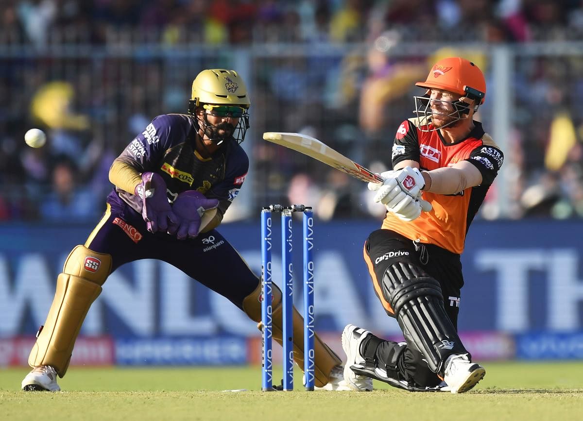 Sunrisers Hyderabad captain David Warner plays a shot as Kolkata Knight Riders captain Dinesh Karthik looks on during the Indian Premier League (IPL) Twenty20 cricket match between Kolkata Knight Riders and Sunrisers Hyderabad at the Eden Gardens Stadium, in Kolkata. AFP Photo