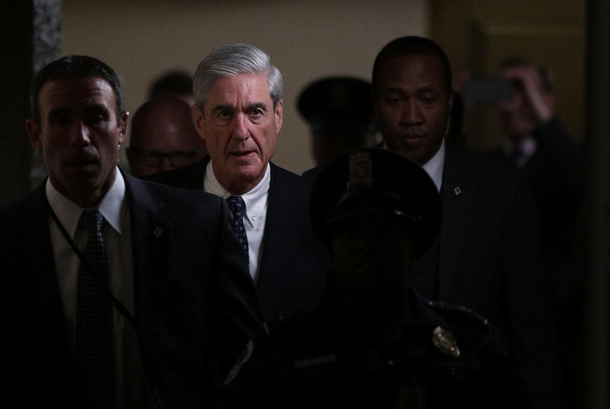 (FILES) In this file photo taken on June 21, 2017, Special counsel Robert Mueller (2nd L) leaves after a closed meeting with members of the Senate Judiciary Committee at the Capitol in Washington, DC. - Special Counsel Robert Mueller has concluded his inv