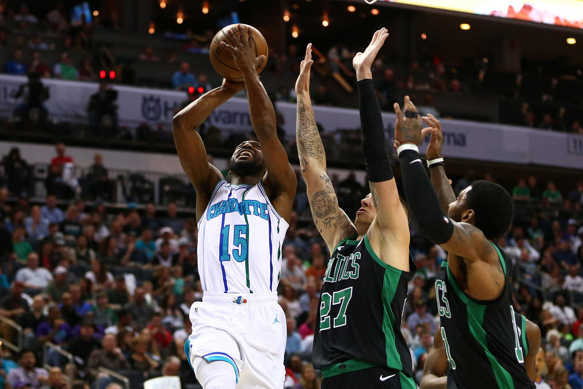 Mar 23, 2019; Charlotte, NC, USA; Charlotte Hornets guard Kemba Walker (15) shoots the ball against Boston Celtics forward Daniel Theis (27) in the first half at Spectrum Center. Mandatory Credit: Jeremy Brevard-USA TODAY Sports