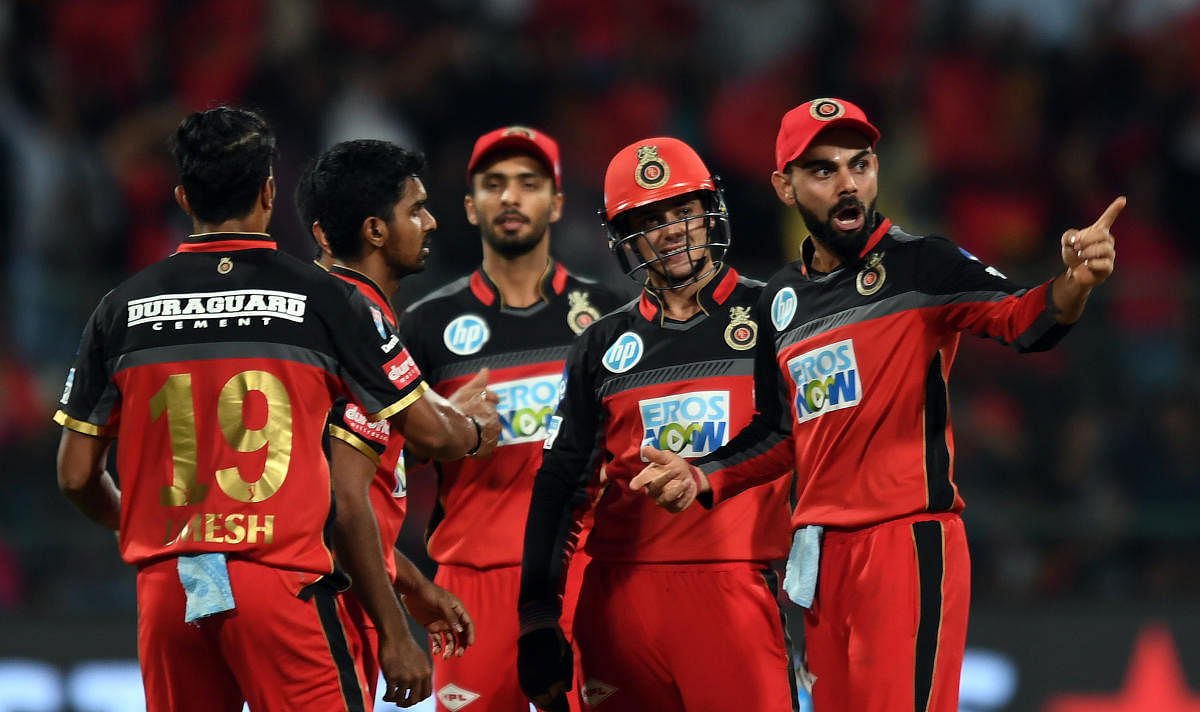 EFFORT IN VAIN Royal Challengers Bangalore players celebrate the dismissal of Kolkata Knight Riders Robin Uthappa during their IPl game on Sunday. DH PHOTO/ SRIKANTA SHARMA R