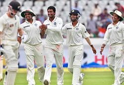 India's bowler Pragyan Ojha, center, celebrates with teammates the dismissal of New Zealand's batsman Kane Williamson, left, during the fourth day of their first cricket test match in Hyderabad, India, Sunday, Aug. 26, 2012. (AP Photo/Mahesh Kumar A.)