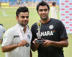 Man of the Match Virat Kohli and Man of the Series R Ashwin pose for lensmen after India won the 2nd test match and series against New Zealand in Bengaluru on Monday. PTI
