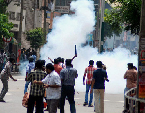 Police use teargas to disperse DYFI activists during a protest over solar scam in Thiruvananthapuram on Tuesday. PTI Photo