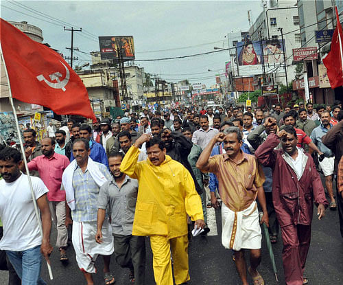 Left Democratic Front workers take out a procession to demand resignation of Kerala Chief Minister Oommen Chandy over the solar scam issue in Kochi on Wednesday. PTI Photo
