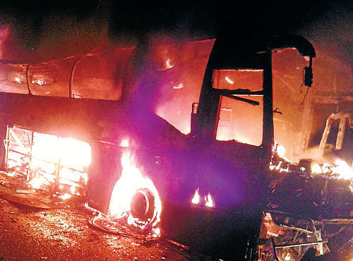 In flames: The multi-axle Volvo bus which caught fire on NH-4 near Haveri on Thursday morning. DH photo