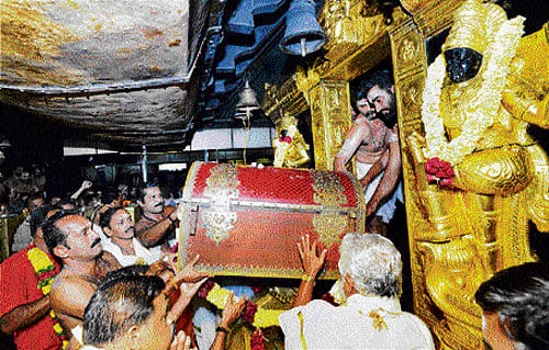 hoary tradition: Chief priest P N Narayanan Namboothiri receives a box carrying the sacred golden attire of Lord Ayyappa called 'Thanka Anki' for Mandala pooja at Ayyappa temple in Sabarimala on Wednesday. PTI