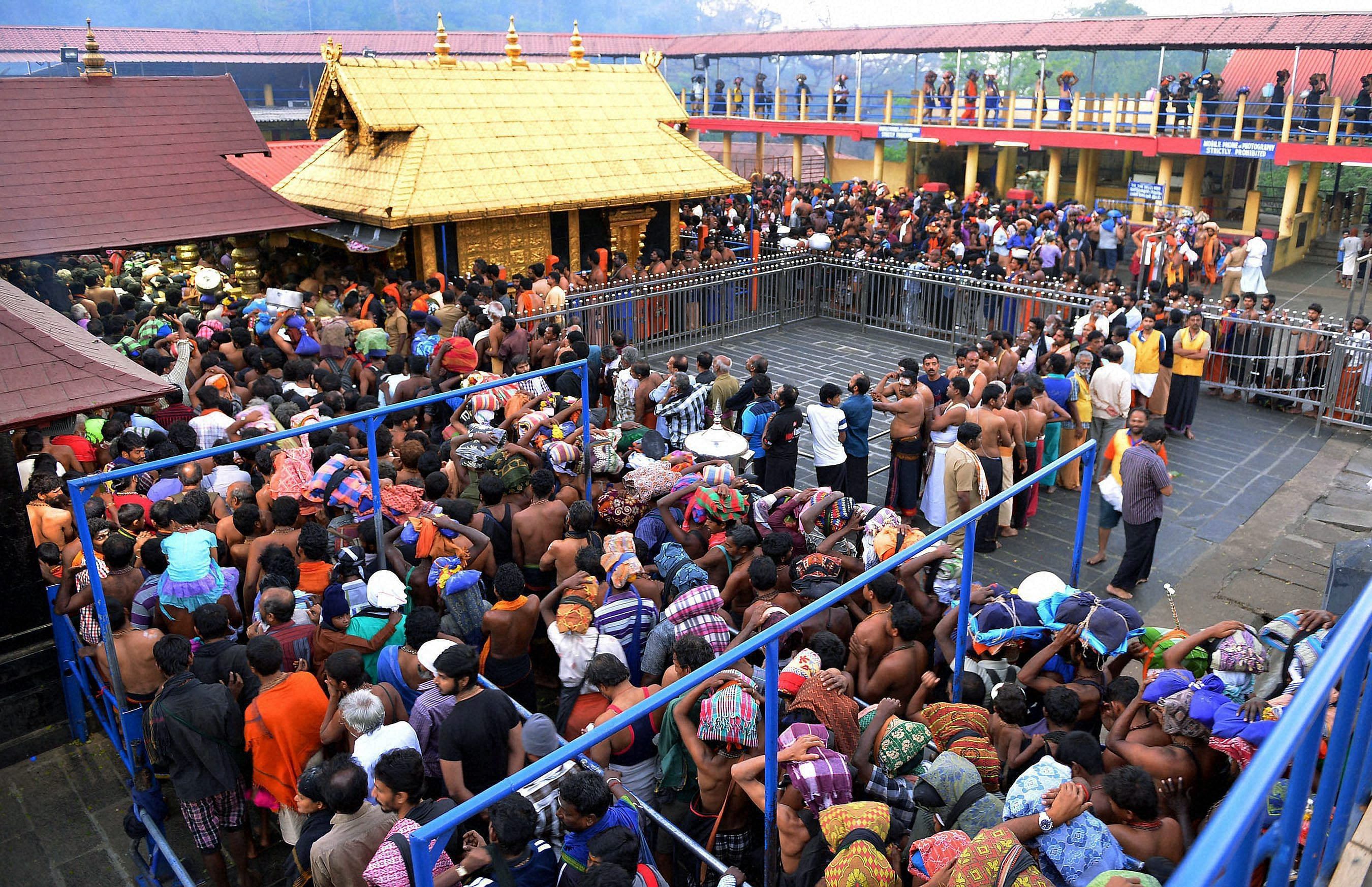 Ayyappa devotees crowd for 'darshan' at Sannidanam ahead of 'Makara Vilakku' in Sabarimala on Saturday. PTI Photo