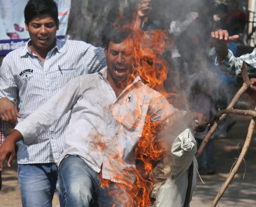 Students from Osmania University supporting the creation of a separate state of Telangana shout slogans as they burn an effigy of Chief Minister of Andhra Pradesh state N. Kiran Kumar Reddy during a protest in Hyderabad. Andhra Pradesh assembly remained paralysed even as the deadline for the state legislature to send its opinion on Telangana bill to the President of India is ending Thursday. AP File Photo