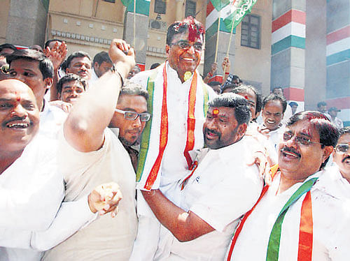 Telangana Congress president Punnala Lakshmaiah  celebrates the party's victory in municipal elections in  Hyderabad on Monday. pti