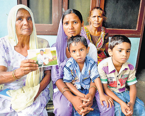 A long wait: Family members of Sonu, believed to be trapped in the troubled city of Mosul (Iraq), show his photograph in Amritsar on Wednesday. PTI