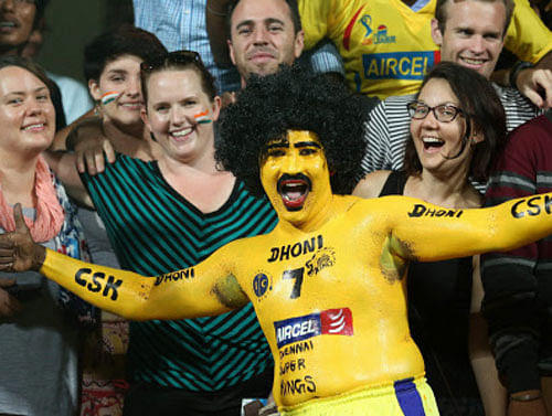 A supporter of Chennai Super Kings cheers during the Champions League Twenty20 match between Chennai Super Kings and Dolphins at Chinnaswamy Stadium in Bengaluru. PTI photo