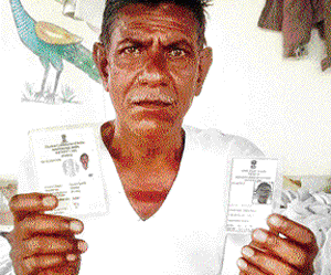 Former sarpanch of Maharajguda village  Chandu Devsinh Pawar displays his two voter identity  cards. DH photo