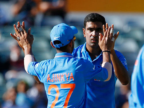 India's bowler Ravichandran Ashwin celebrates with team mate Ajinkya Rahane after bowling out UAE's Mohammed Naveed during their Cricket World Cup match in Perth. Reuters Photo.