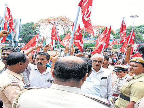 CPI members stage a protest in front of the Deputy Commissioner's office in Mangaluru on Thursday. dh photo