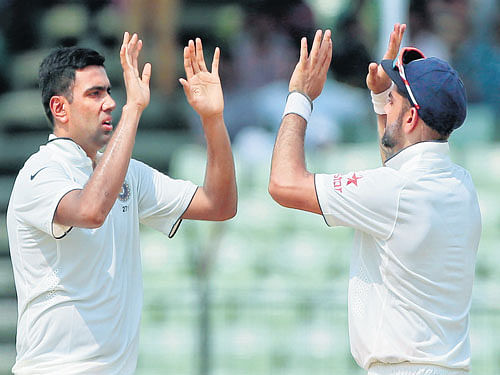 casting a web: R Ashwin (left) celebrates with Virat Kohli after dismissing a Bangladeshi batsman on Sunday. AP