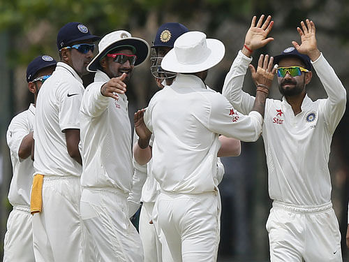India's captain Virat Kohli (R) celebrates with his teammates Shikhar Dhawan (front) , Ravichandran Ashwin (L) and Harbhajan Singh (2nd L) after the dismissal of Sri Lanka's Kaushal Silva (not pictured) during the first day of their first test cricket match in Galle August 12, 2015. Reuters  Photo.