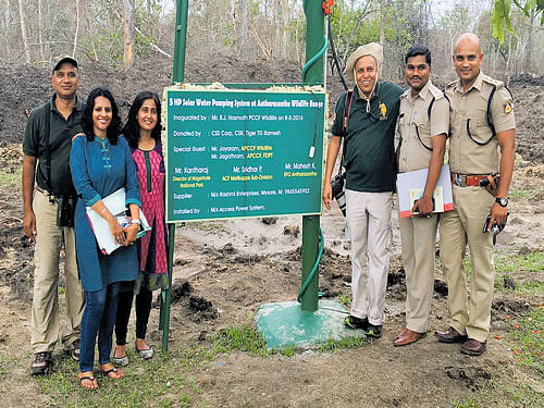 Forest department personnel, along with CSS Corp CEO&#8200;Tiger Ramesh and CSS&#8200;Corp Senior Director (marketing) Smitha Hemmigae, seen during the launch of the Solar Water Pumping System at Anthrasante Forest, under Nagarahole Tiger Reserve (NTR), in Mysuru district.