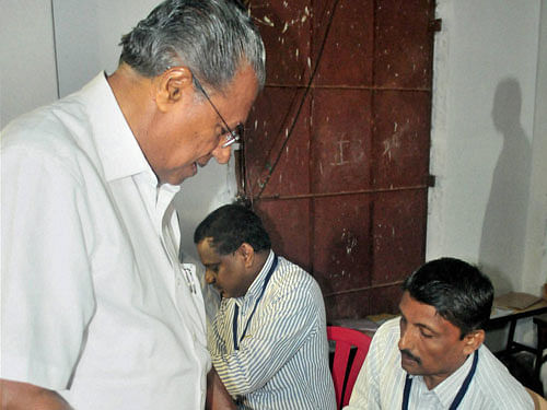 CPI(M) polit bureau member and LDF chief ministerial aspirant Pinarayi Vijayan arrives to cast his vote at a polling station during Assembly elections in Kannur district on Monday. PTI Photo