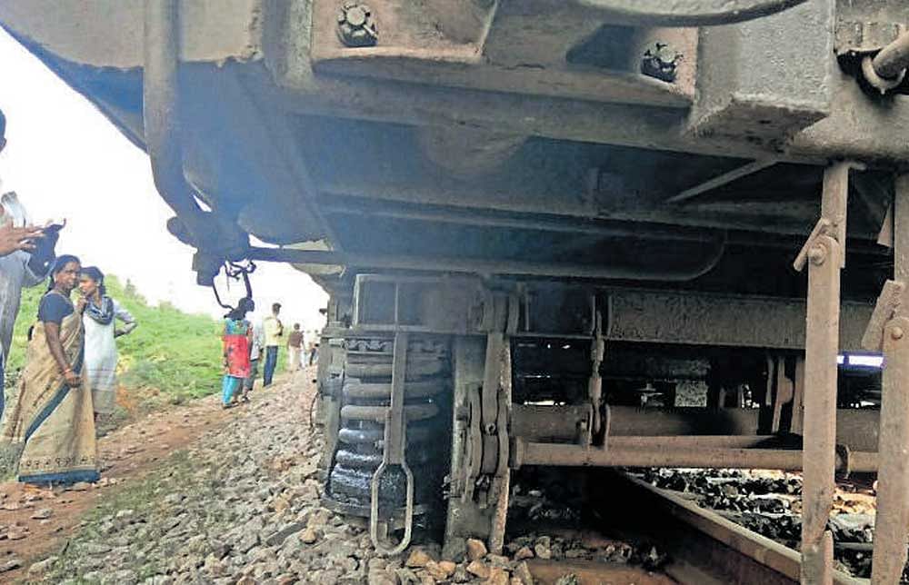 The derailed wheels of one of the compartments of the  Bengaluru-Hosapete passenger train on the rail overbridge in Chitradurga. dh photo
