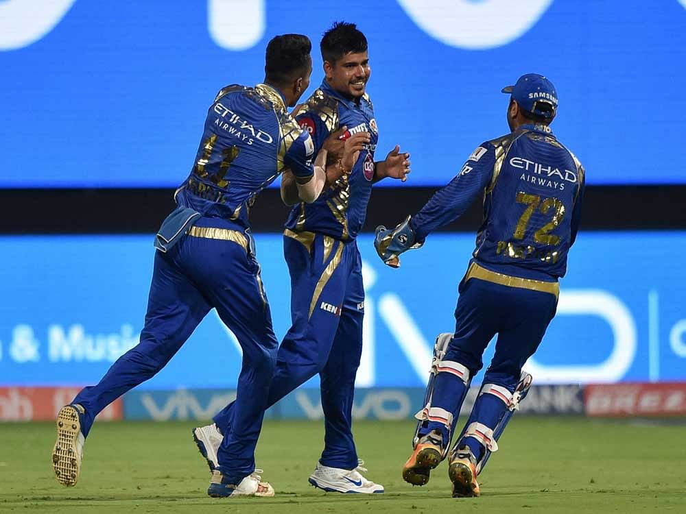 Mumbai Indians Karn Sharma with team mates celebrate the wicket of Colin De Grandhomme during the IPL 10 Qualifier2 match between Kolkata Knight Riders and Mumbai Indians at Chinnaswamy Stadium in Bengaluru on Friday. PTI Photo